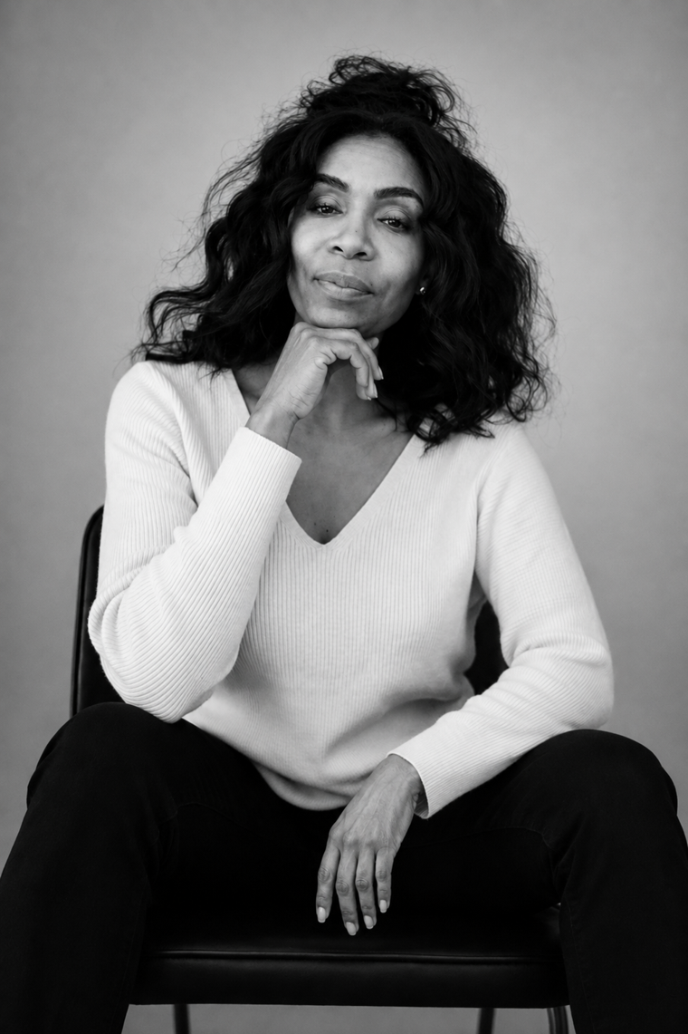 Portrait of the founder of CHE Realty Property Management, seated and looking toward the camera